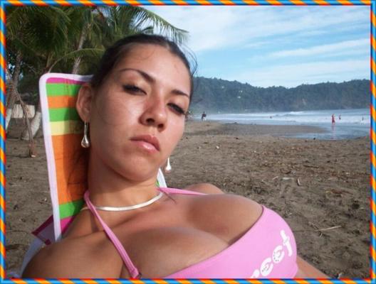 Amateur girl with fake tits on the beach