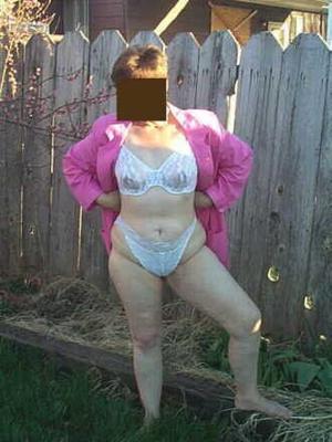 wife posing outside to send pics to men