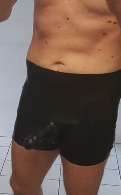 Gummi-Latex-Shorts schwarz mit Kondom und steifem Schwanz