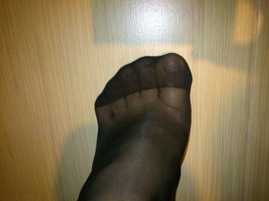 Male feet in black pantyhose