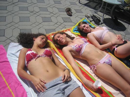 Ladies in bikinis poolside, at home, but not at the beach.