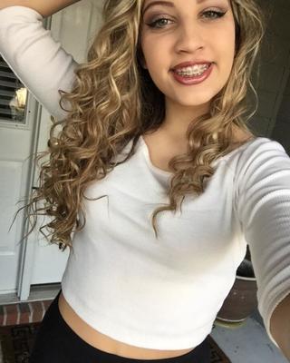 Cute Young Cheerleader with a Great Body, Great Hair, and Braces