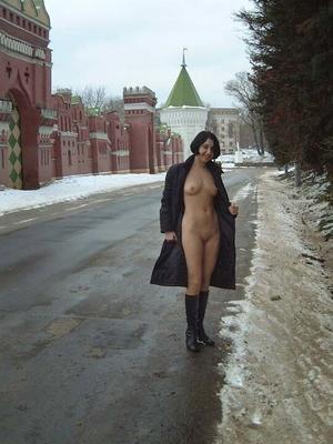 Nude Russian brunette walking on the snow