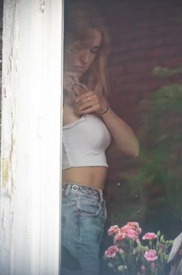 Blonde girl flashing tits in window