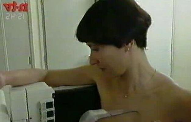 Black-haired young German woman having a mammogram