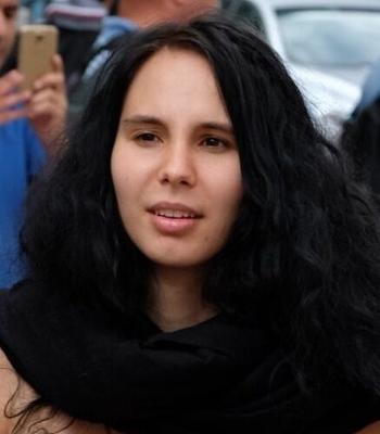 WNBR - A girl with long black curls and a black scarf